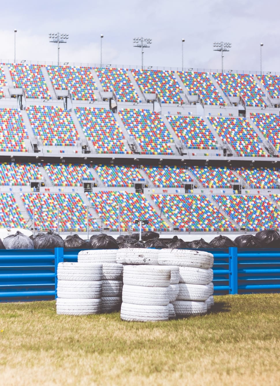 white automotive tires beside blue fence preview