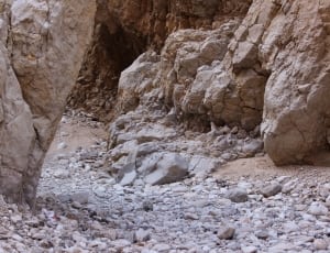 brown rock shards beside rock wall during daytime thumbnail