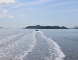 speedboat cruising to an island thumbnail