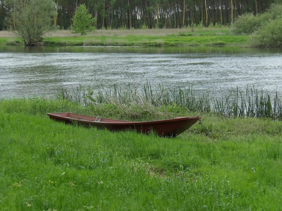 brown wooden boat on green grass field preview