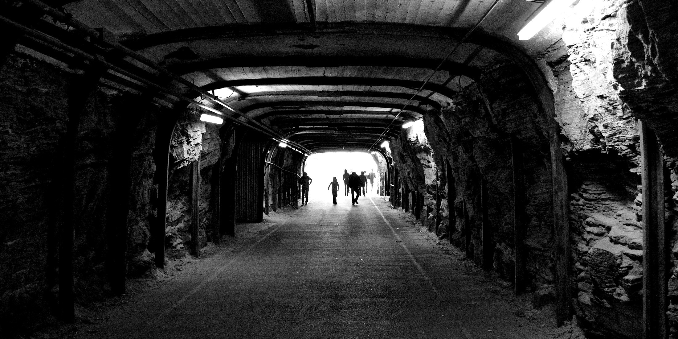 grayscale photo of tunnel