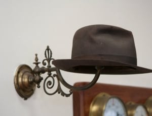 black hat and gray metal sconce hat holder thumbnail