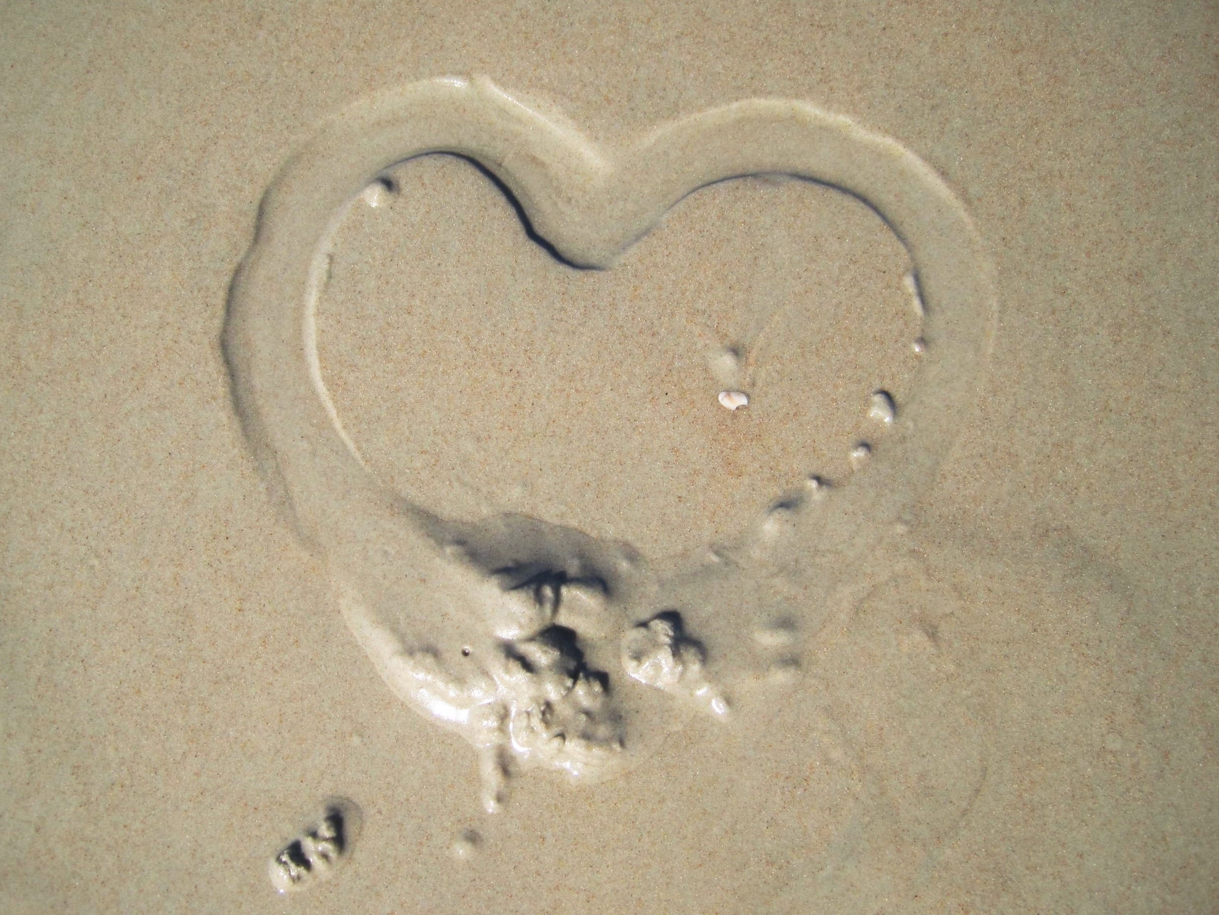 heart on wet sand