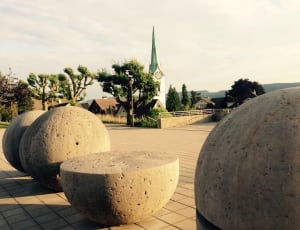 gray concrete round statues thumbnail