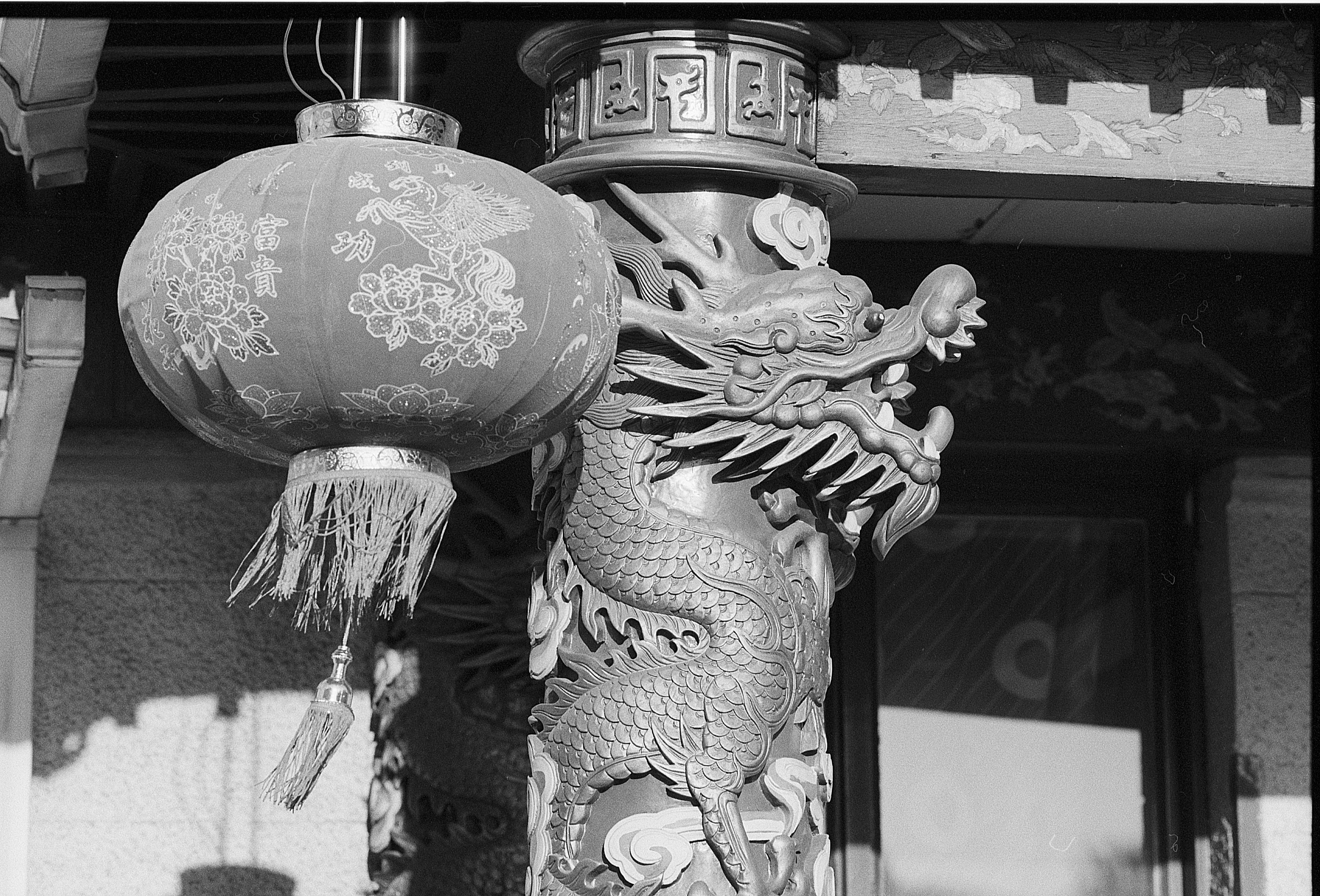 gray hanging lantern near a dragon totem