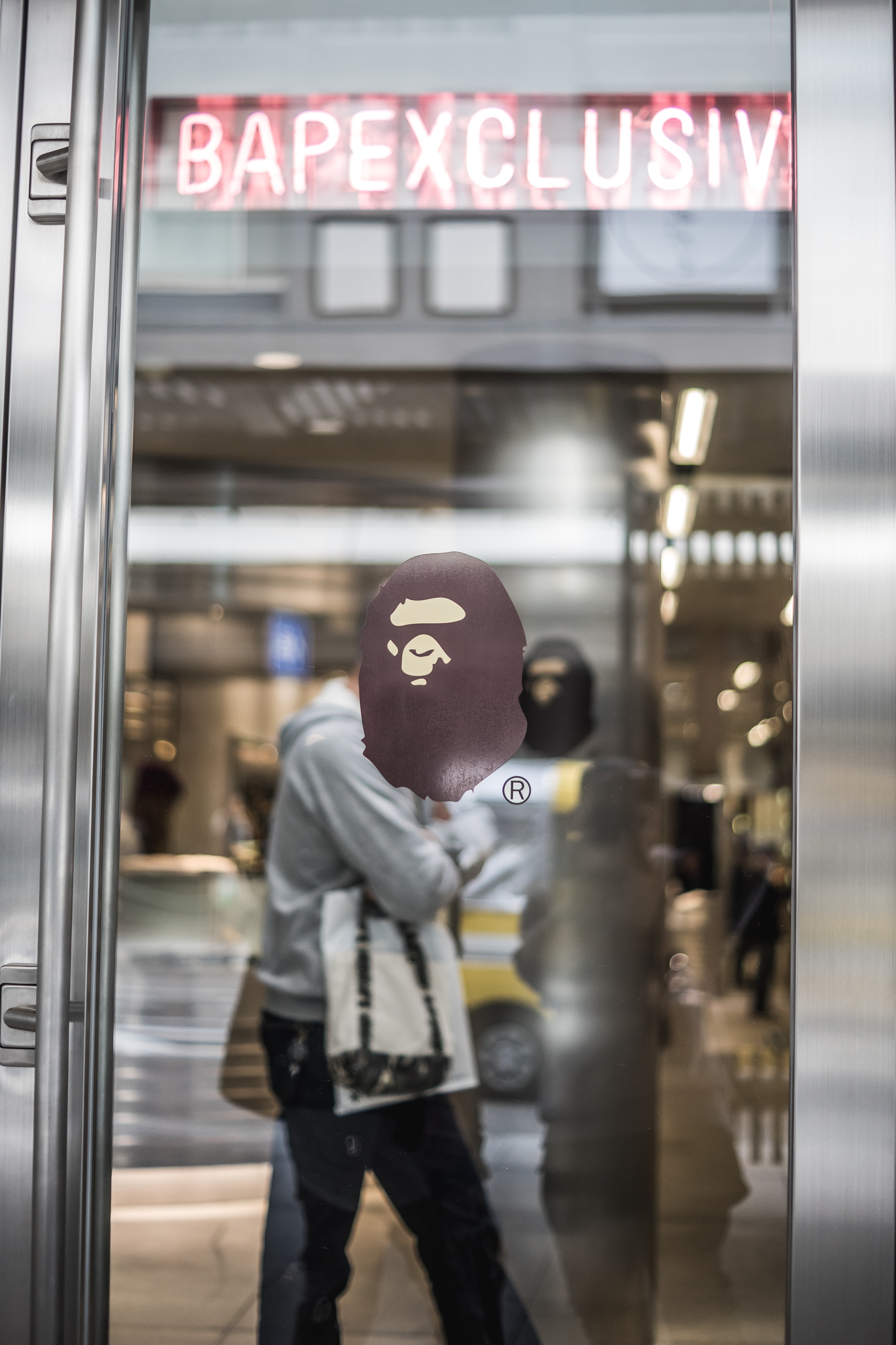 person walking on subway glass reflextion
