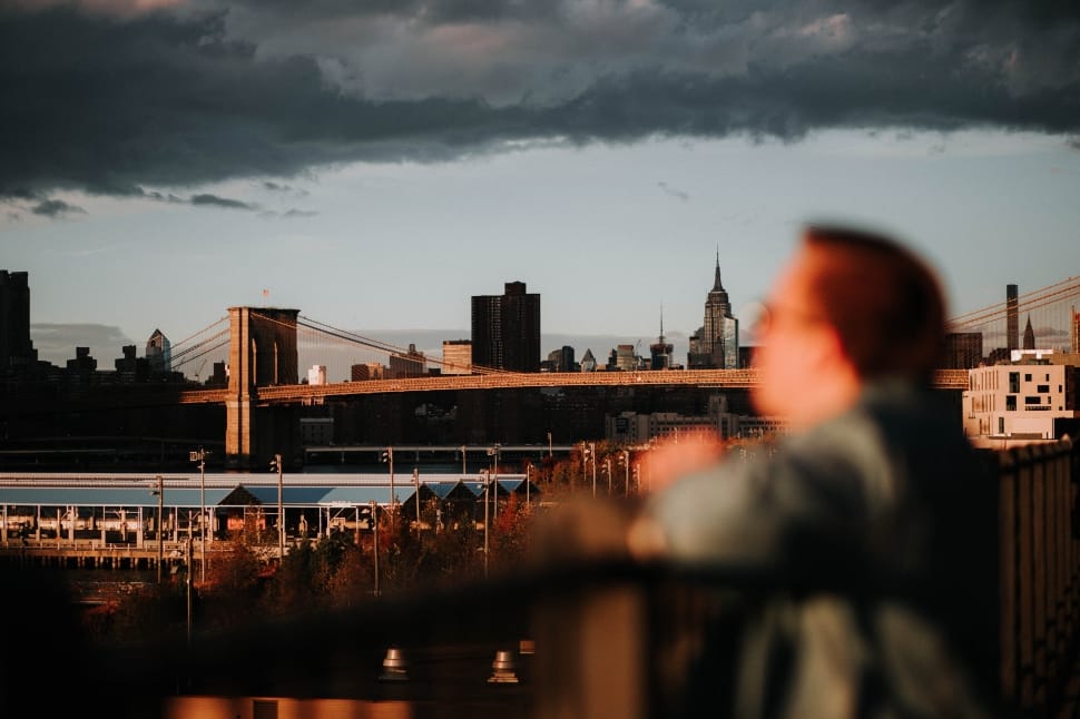 brown haired man watching a view of a city preview