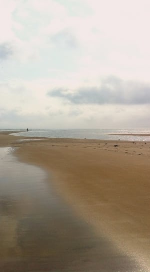 brown sand and a person during daytime thumbnail