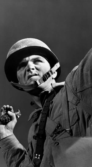 grayscale photo of solider holding grenade thumbnail