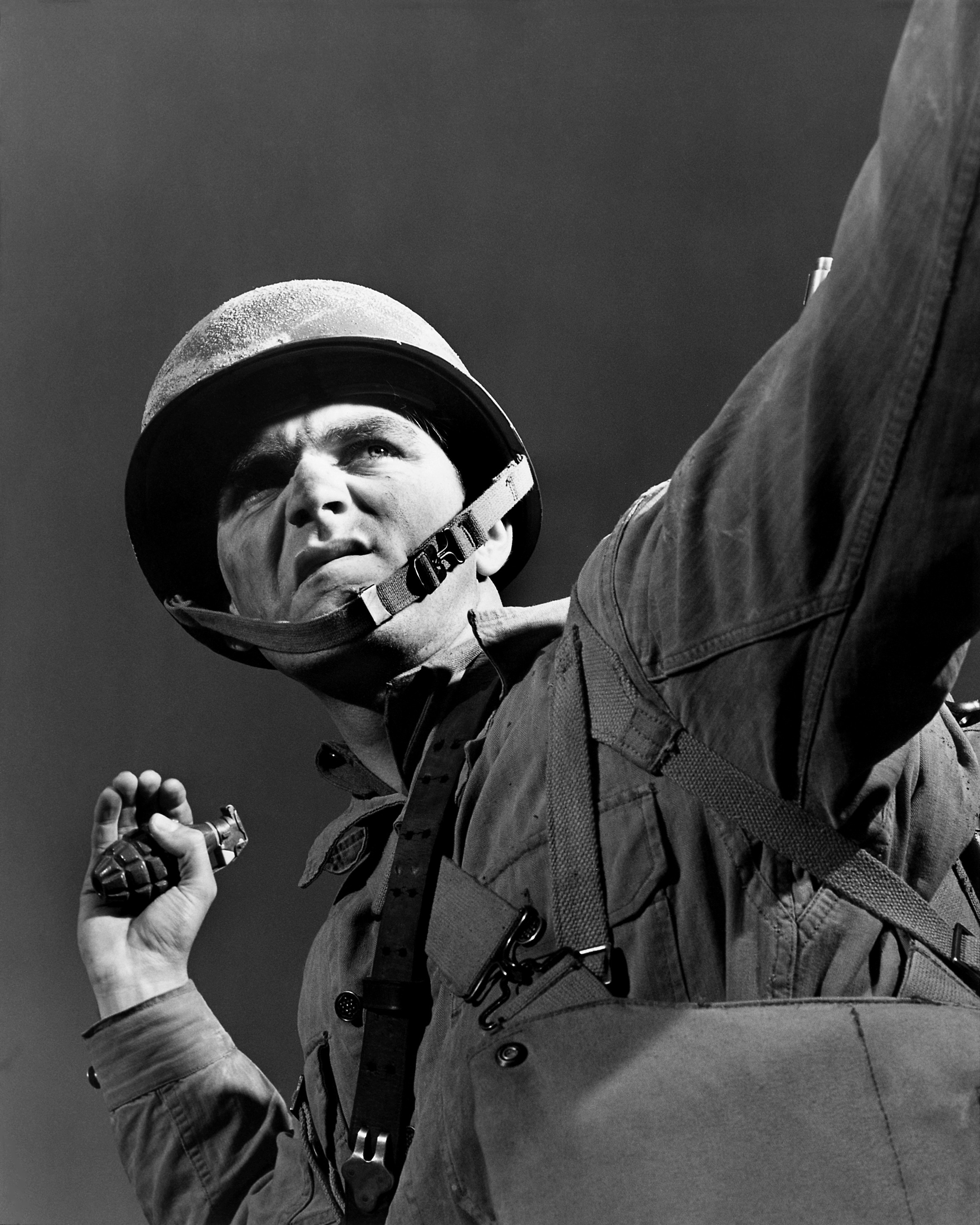 grayscale photo of solider holding grenade