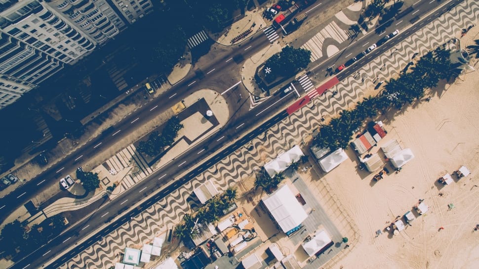 high angle of high way with cars passing by beside high rise building during daytime preview