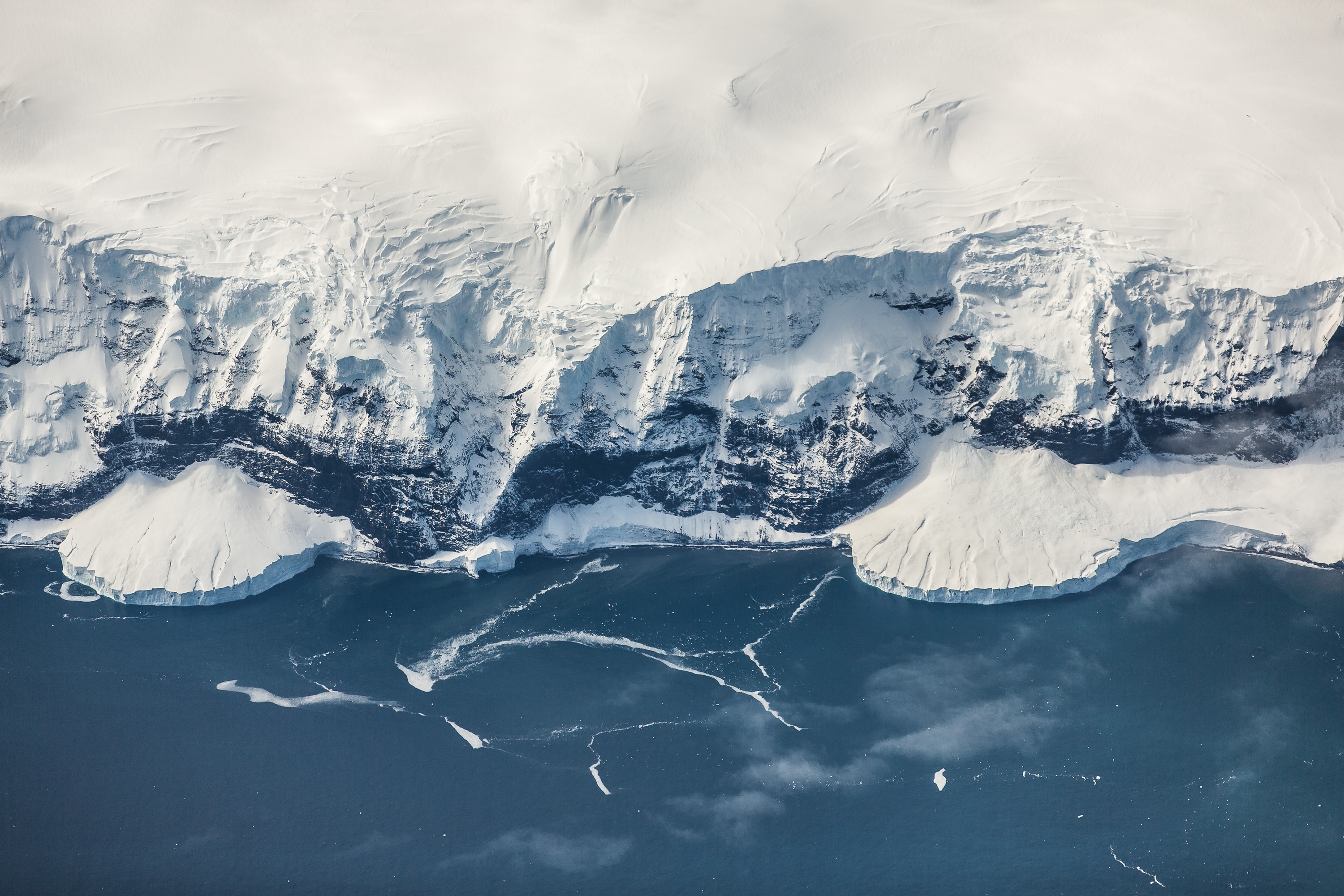 aerial photography of snow coated cliff