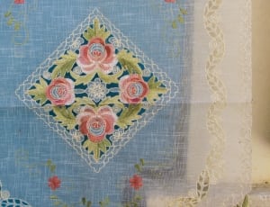 green white and blue floral textile thumbnail
