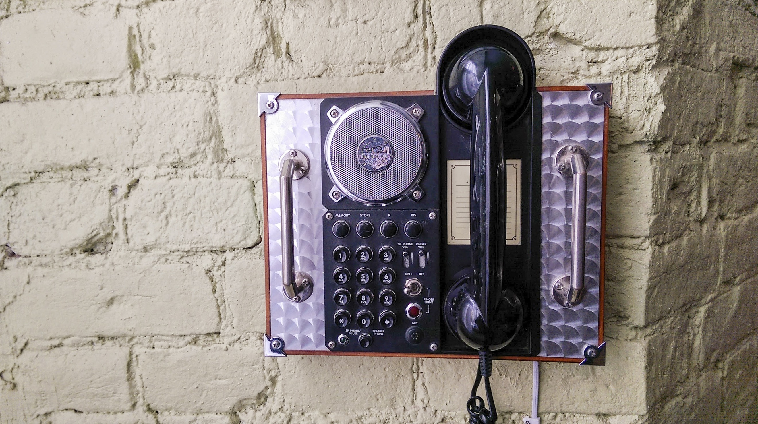black and silver wall mount telephone