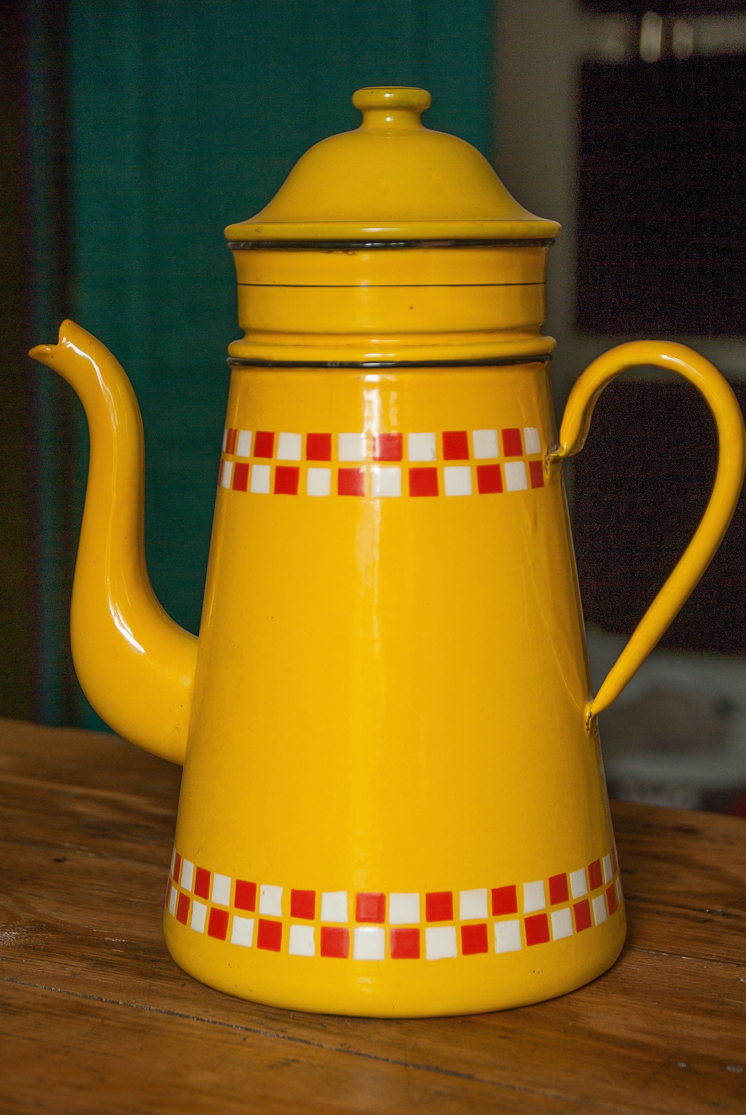 yellow white and red ceramic teapot