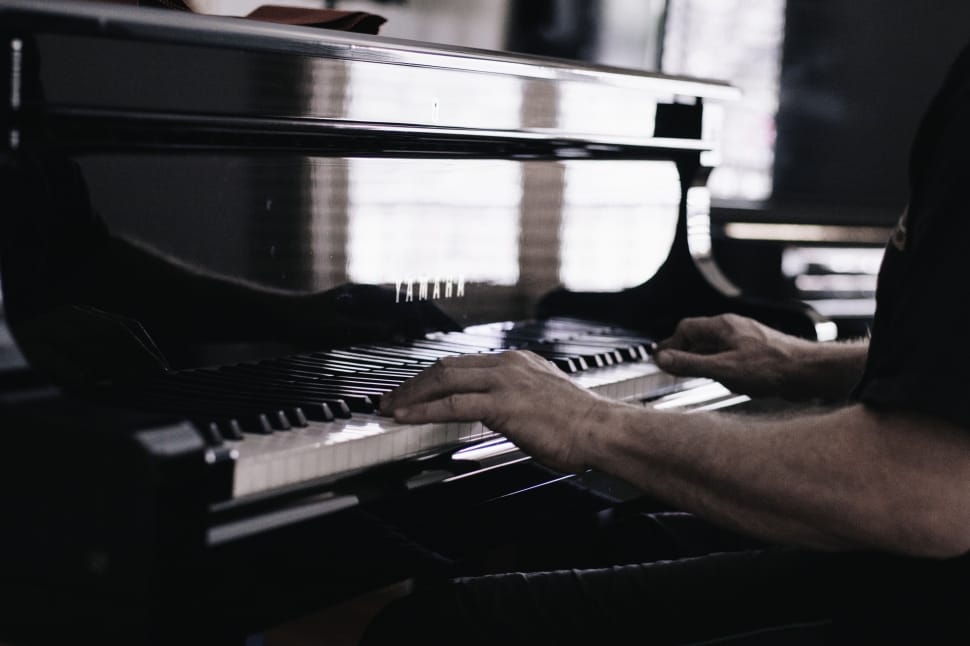 person playing black and white piano keyboard preview