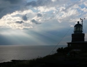 silhouette photo of lighthouse thumbnail