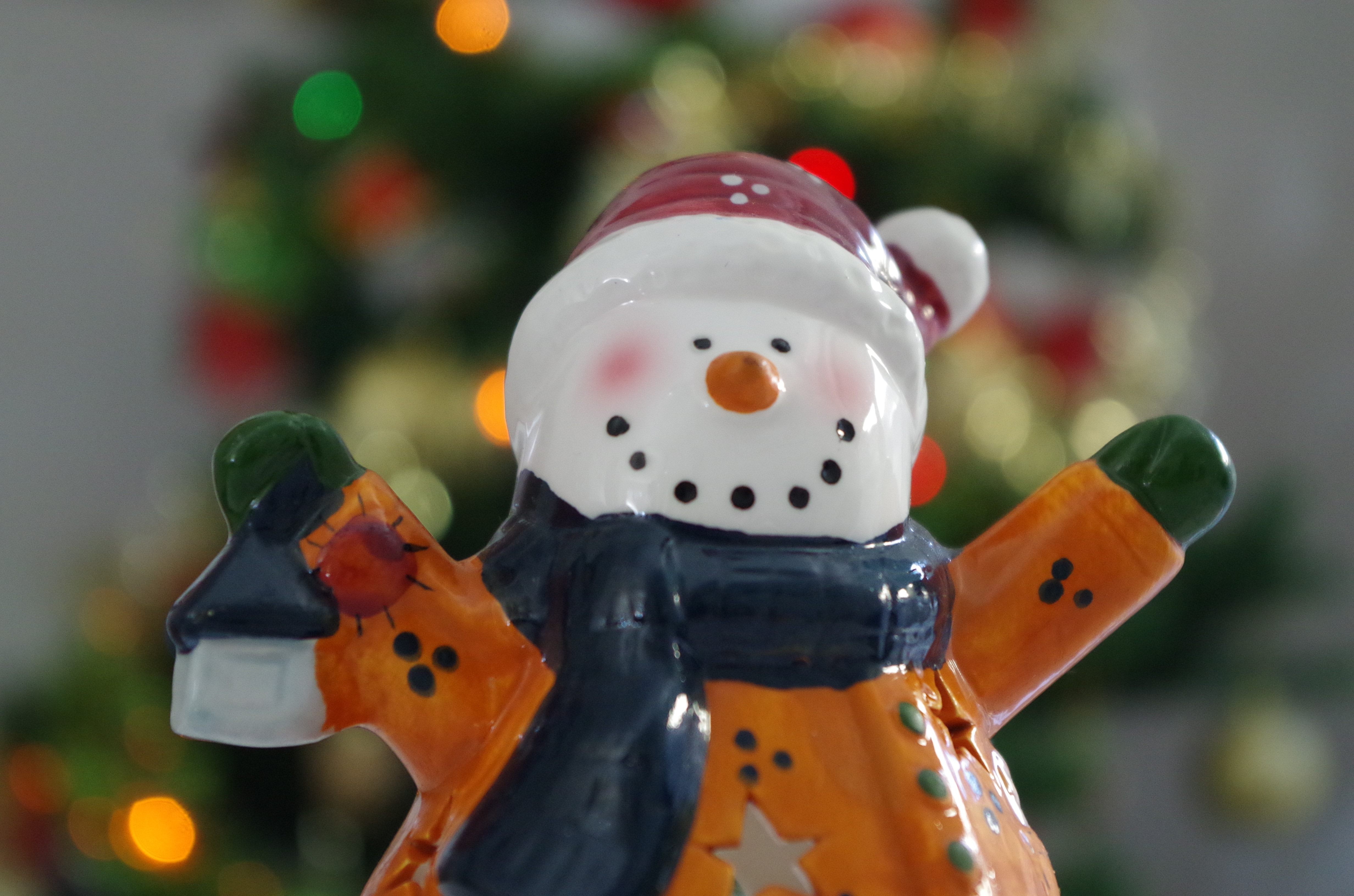 snowman in black scarf ceramic figurine