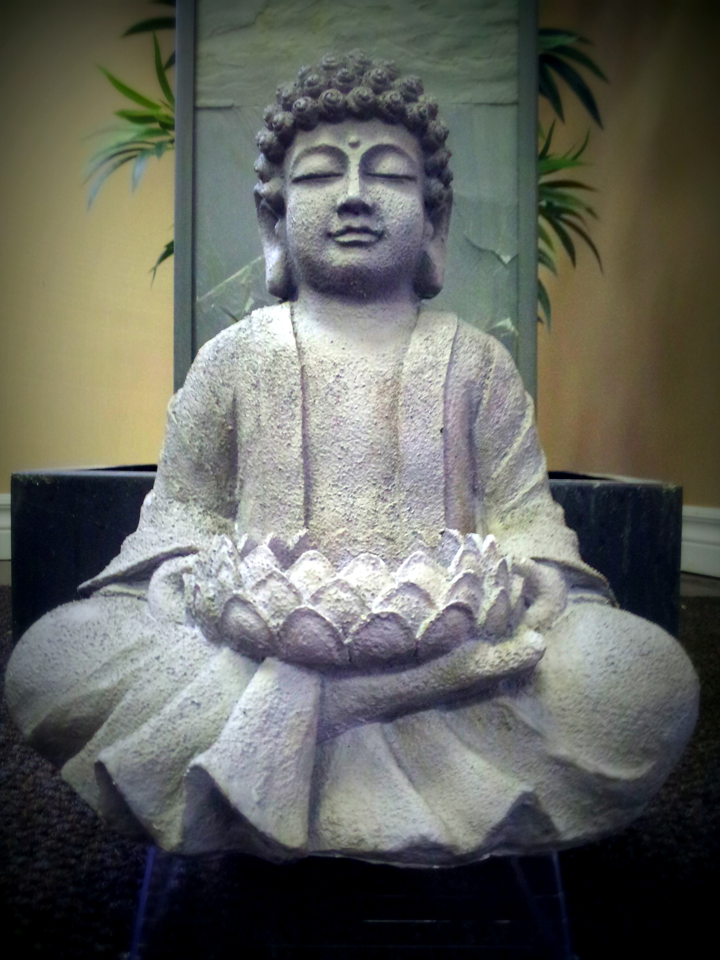 gray ceramic buddha figurine