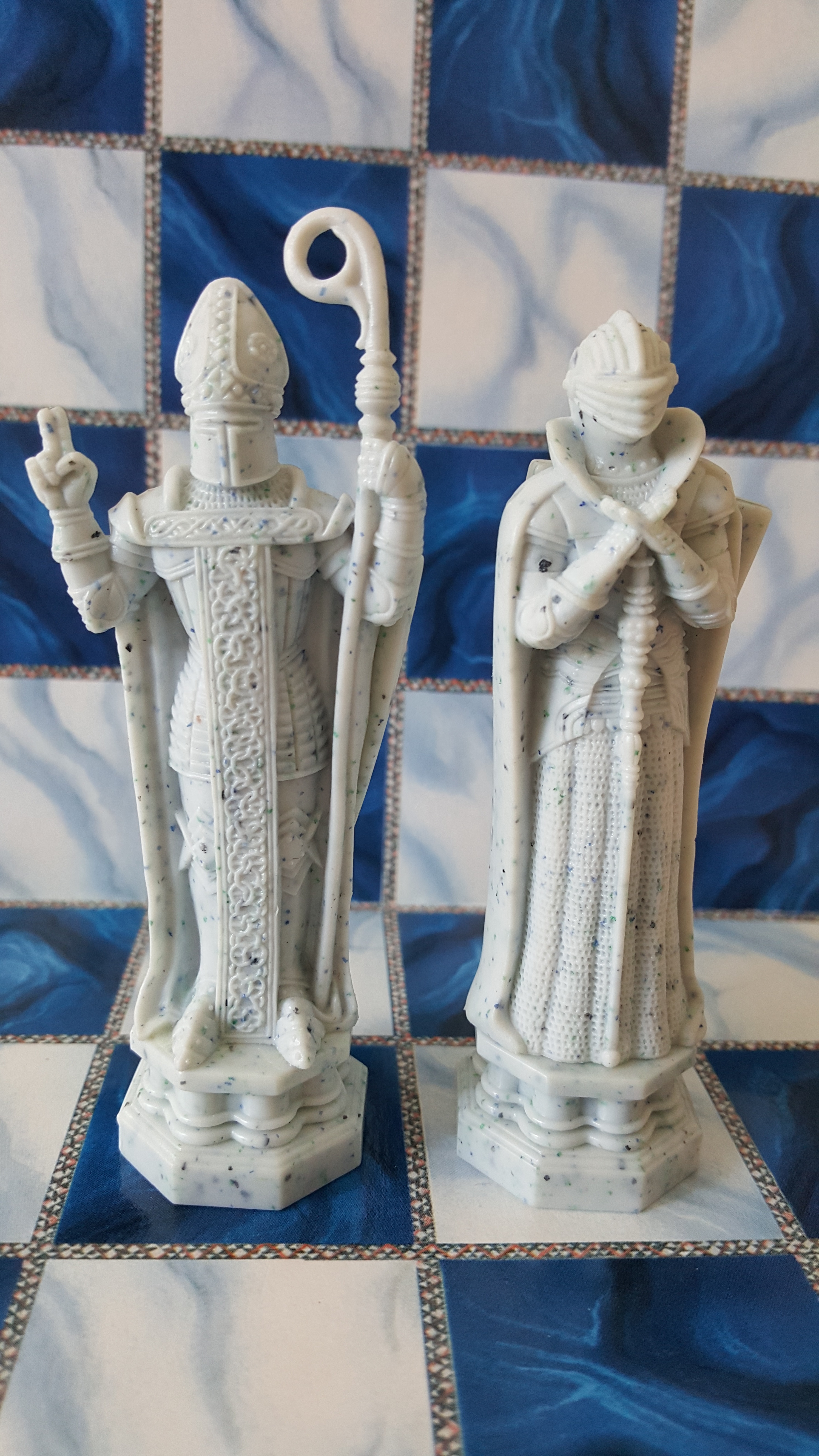 2 white and blue ceramic priest figurine