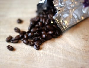brown coffee beans on beige board thumbnail