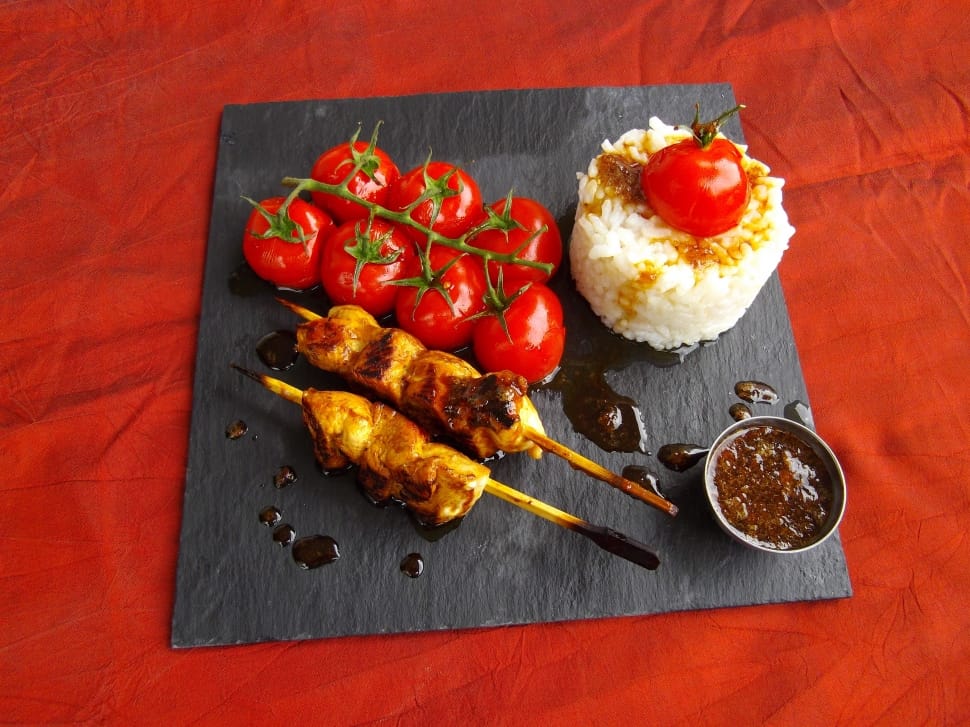 cooked meat on stick with tomatoes and rice meal preview