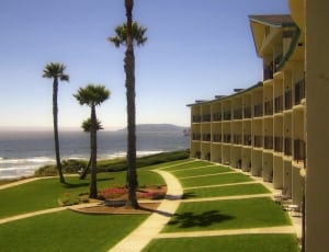 green landscape and concrete building near the ocean thumbnail
