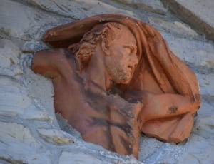 brown high relief statue of man thumbnail