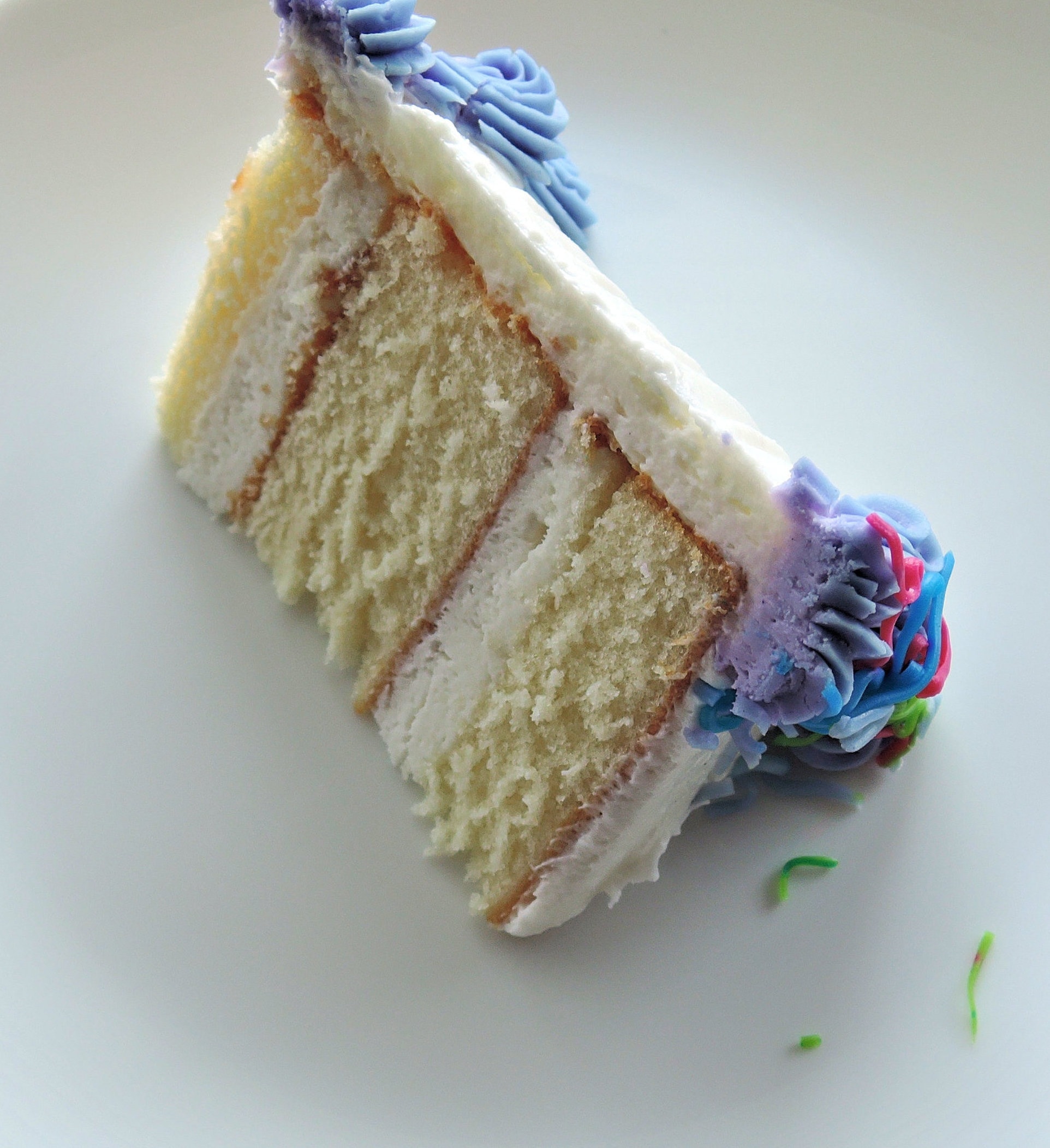 sliced icing cake on white surface