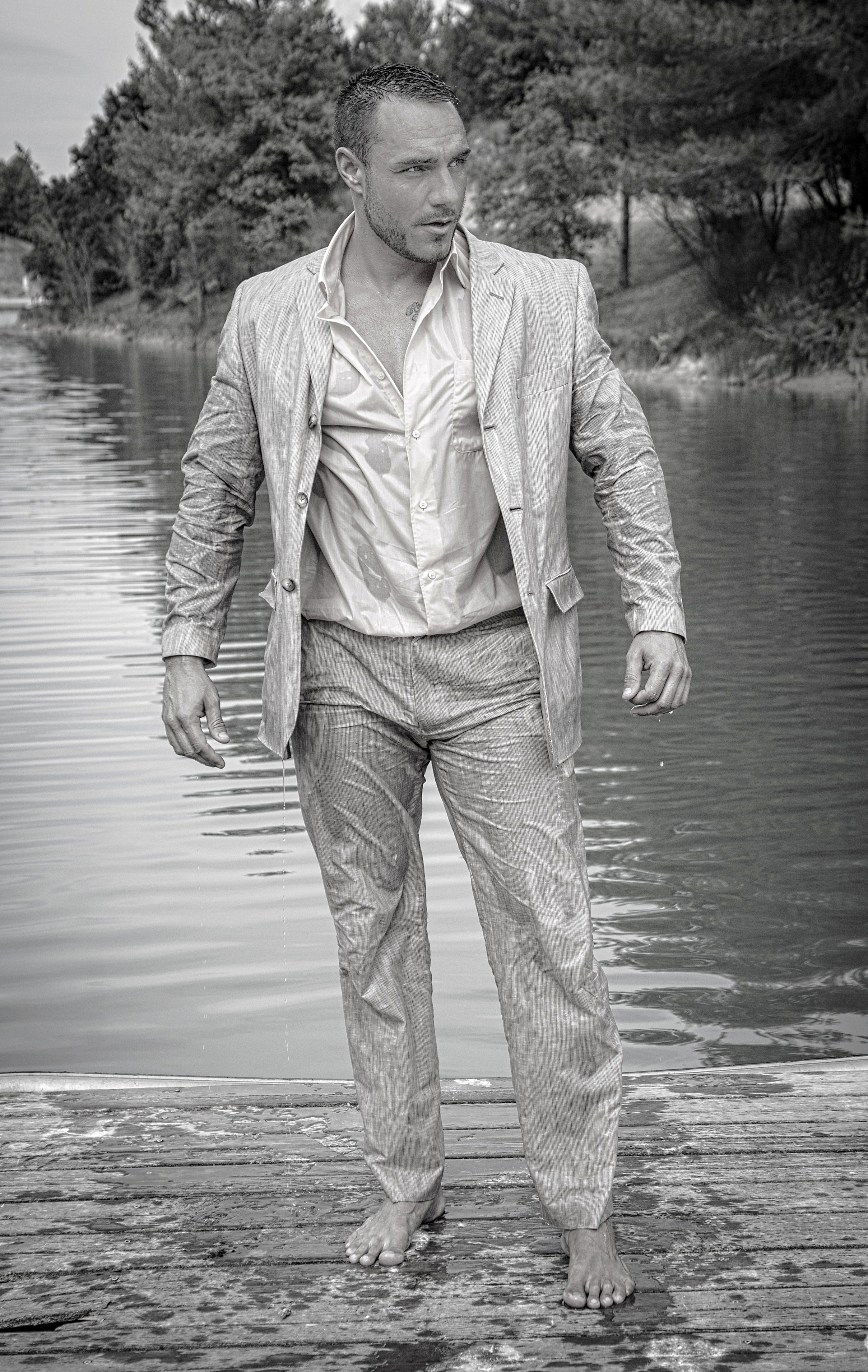 grayscale photo of man wearing blazer and wet