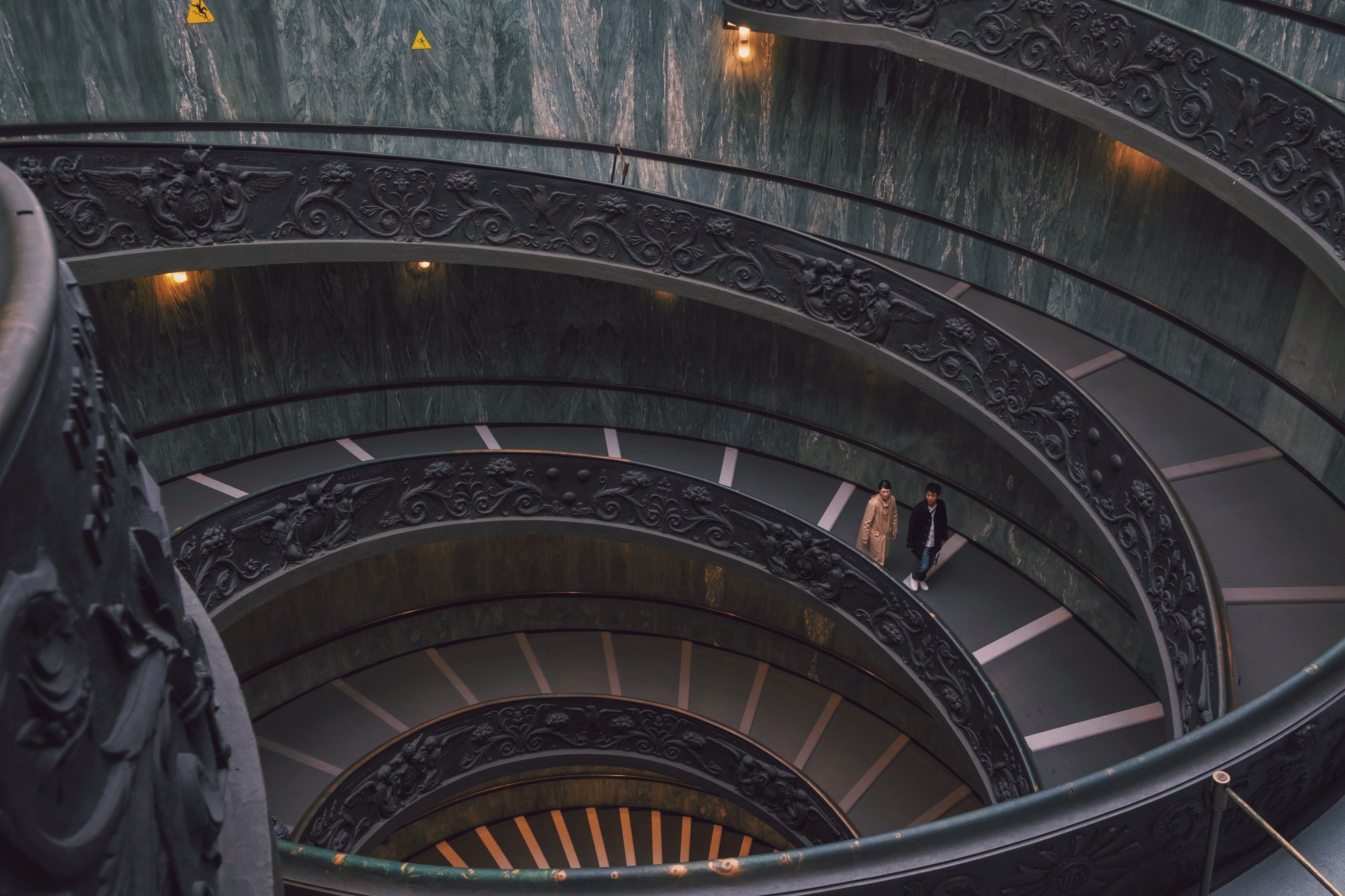 two men walking on spiral staircase