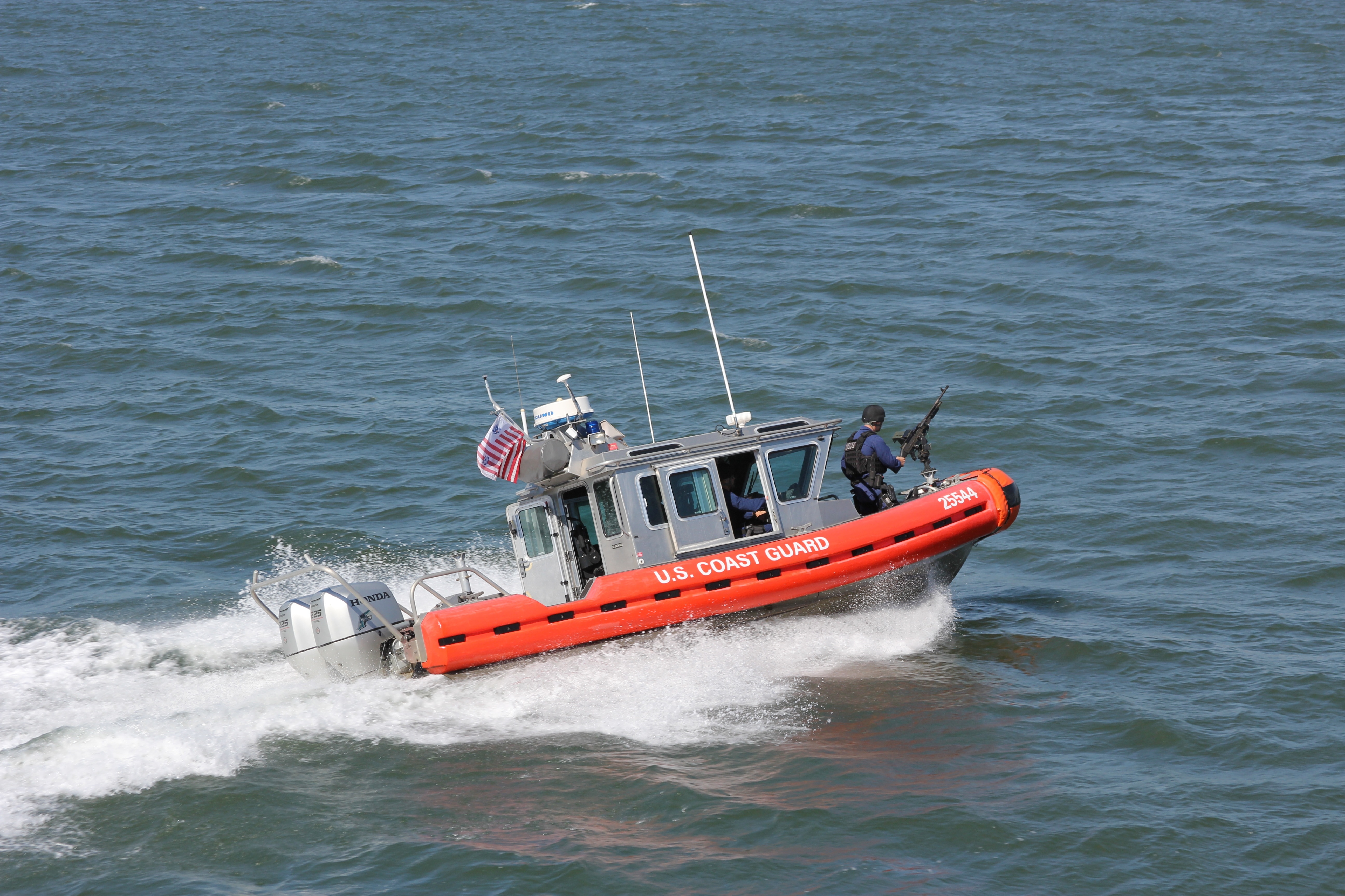 gray and orange u.s coast guard on body of water