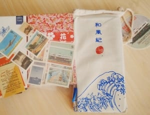 white blue and orange textiles with postage stamps thumbnail
