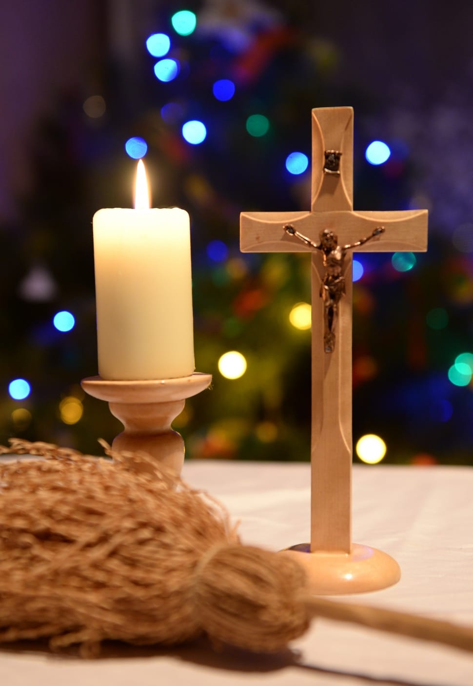 brown cross and white pillar candle decor preview
