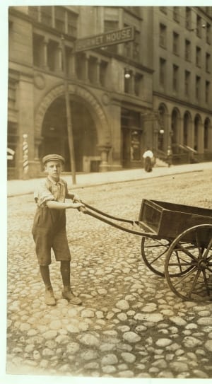 man holding push cart thumbnail