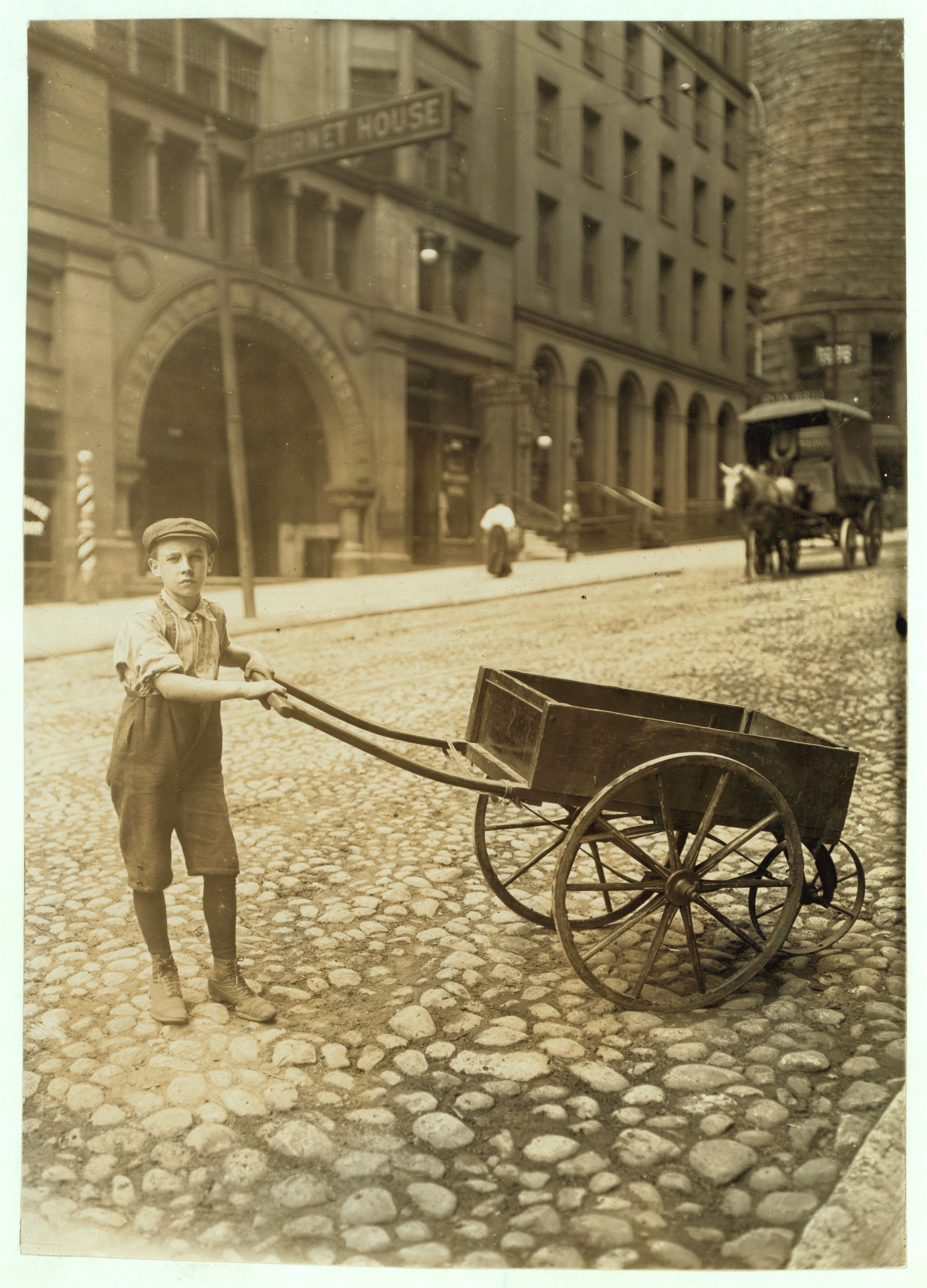 man holding push cart
