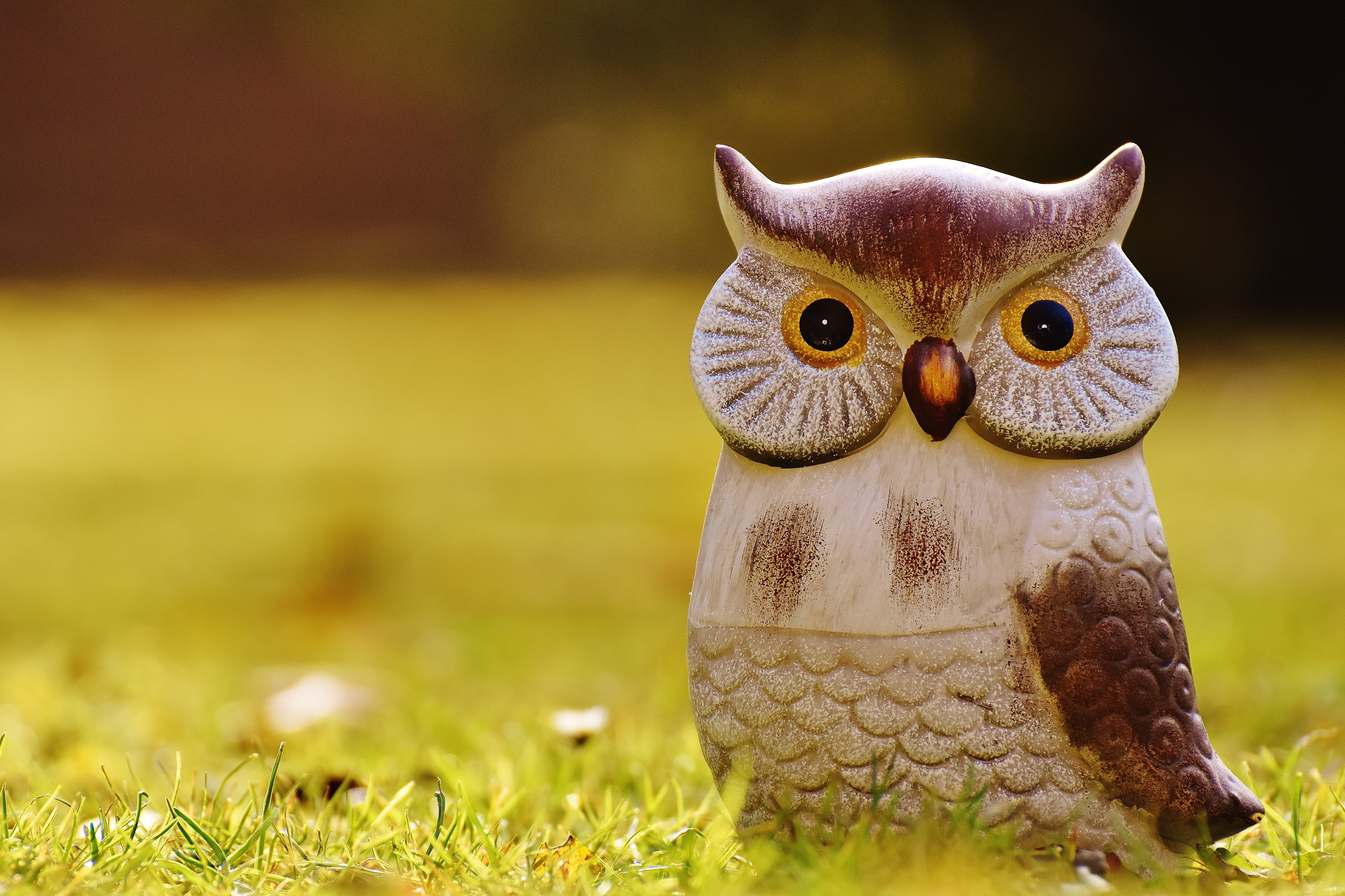 white and brown owl figurine