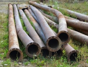 brown metal pipes on ground thumbnail