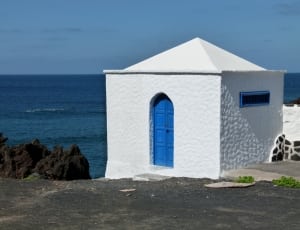 white concrete house with blue door thumbnail