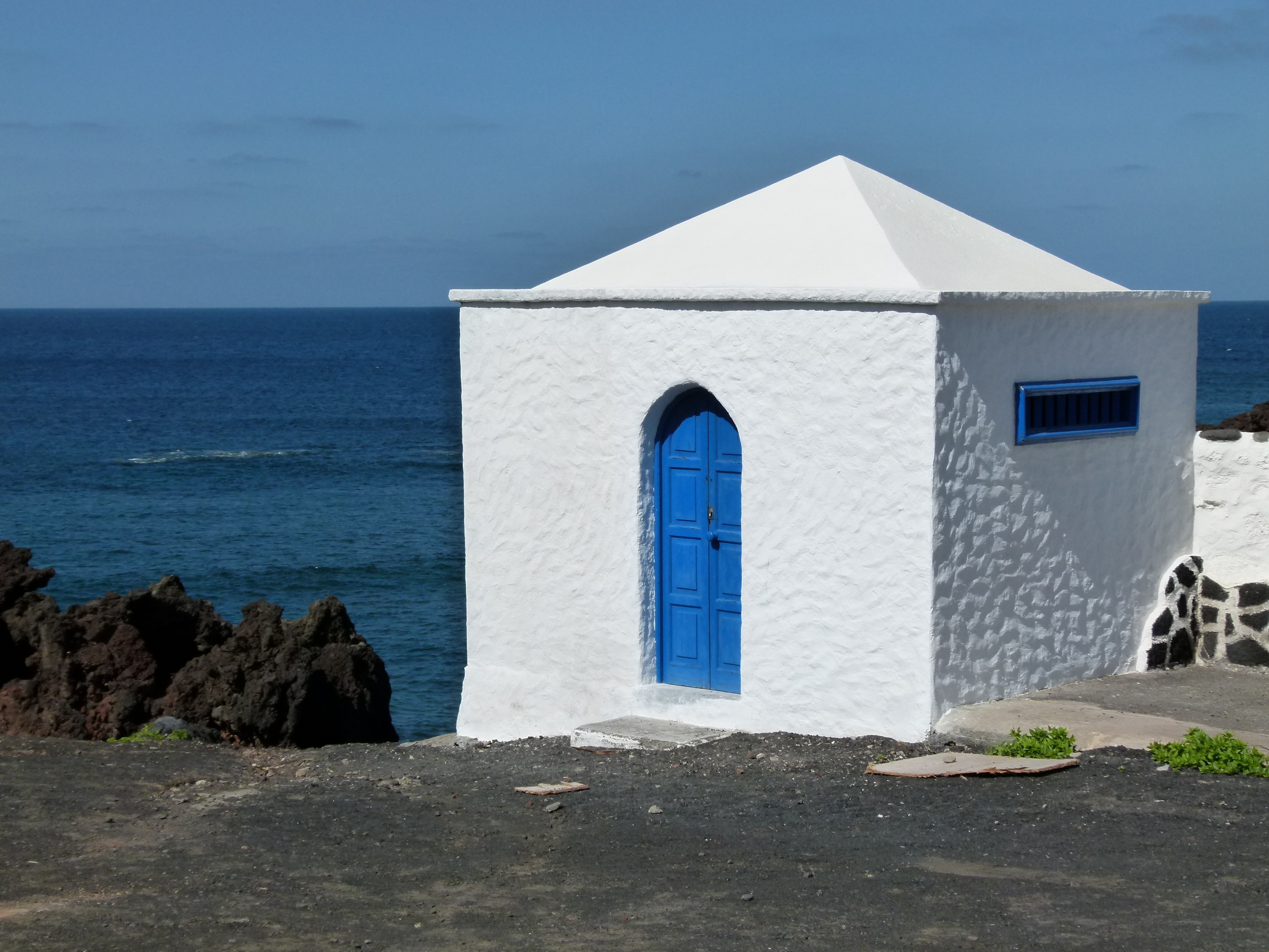 white concrete house with blue door