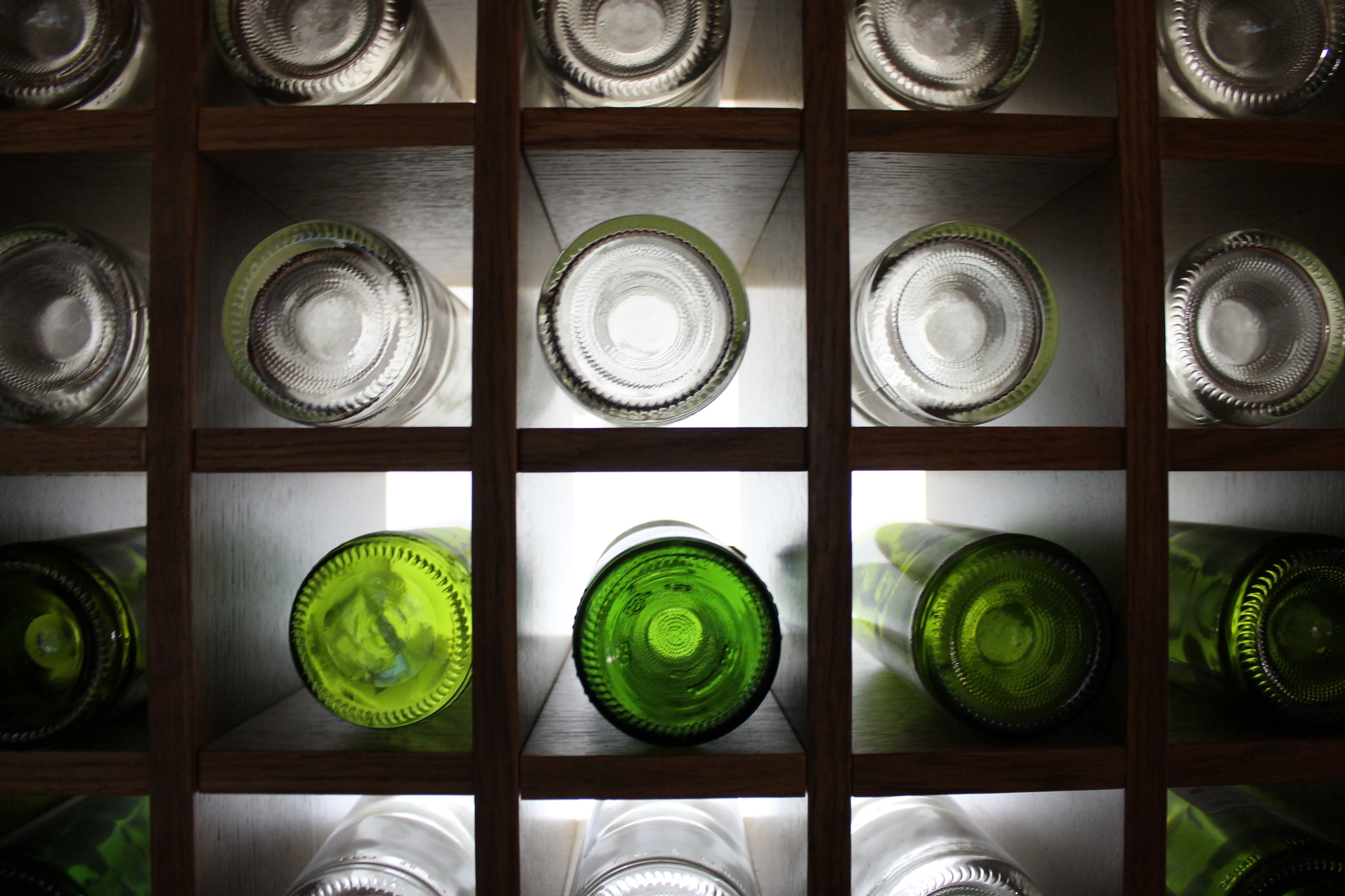 assorted glass bottle with wooden rack