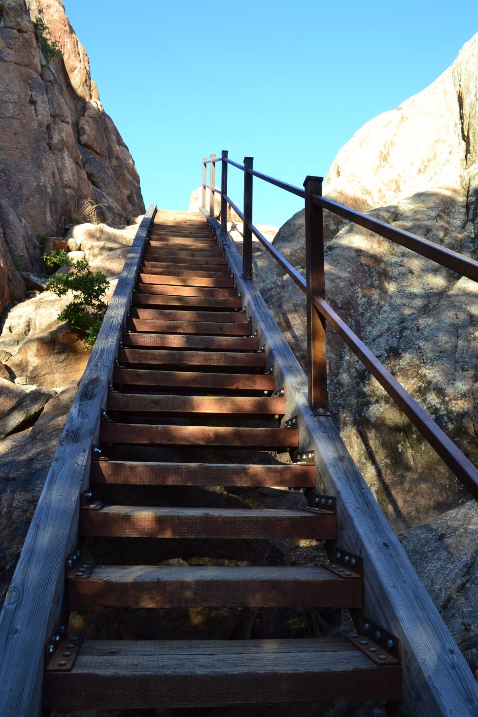 brown wooden stairs beside rocky mountains preview