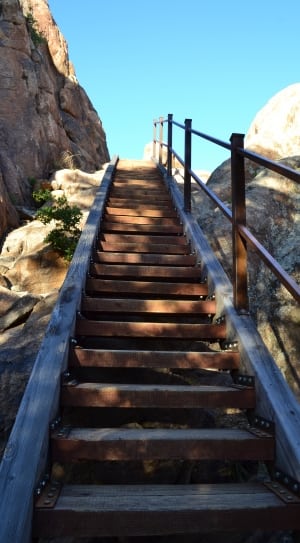 brown wooden stairs beside rocky mountains thumbnail