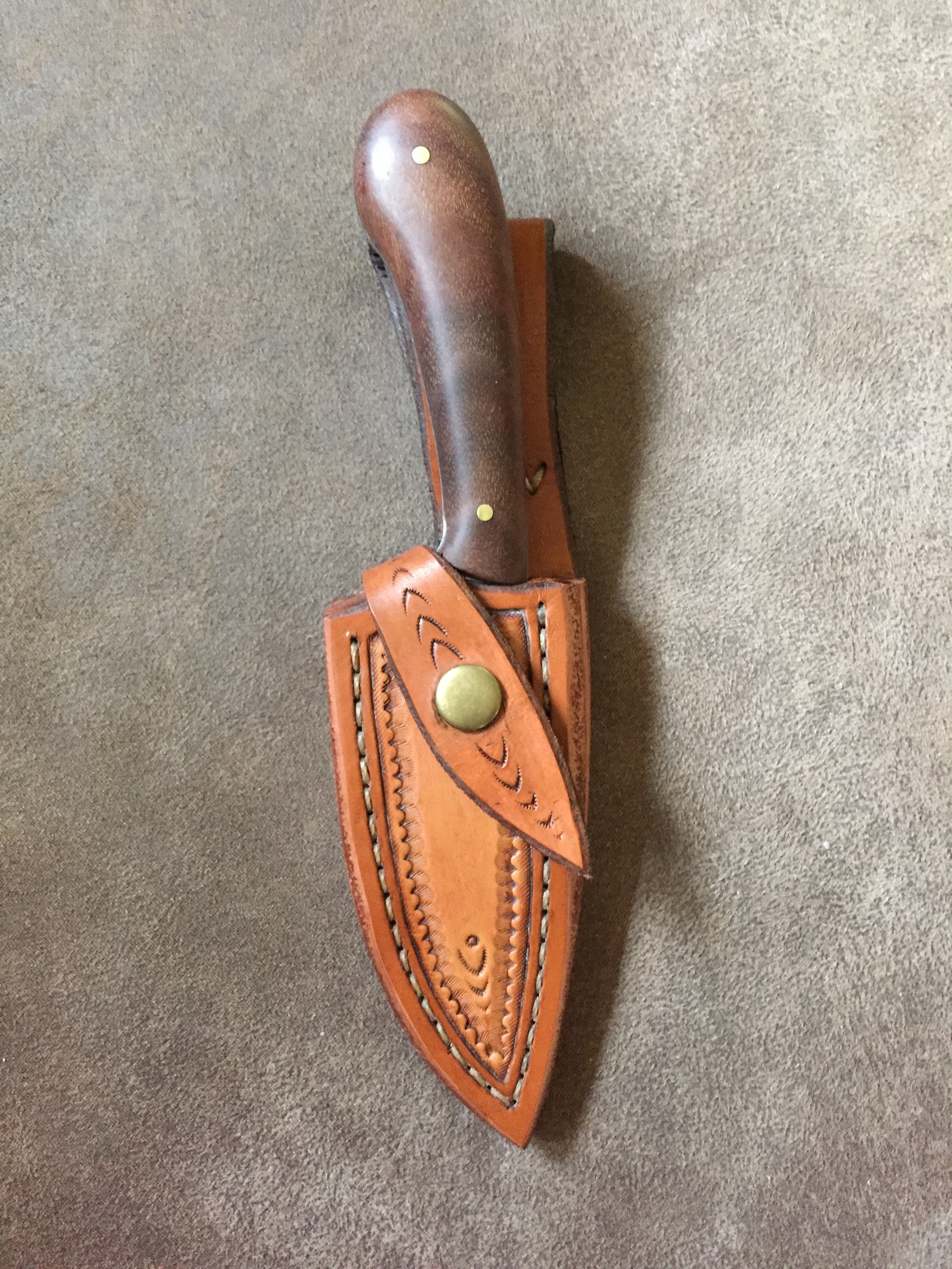 brown handled knife with brown leather sheath