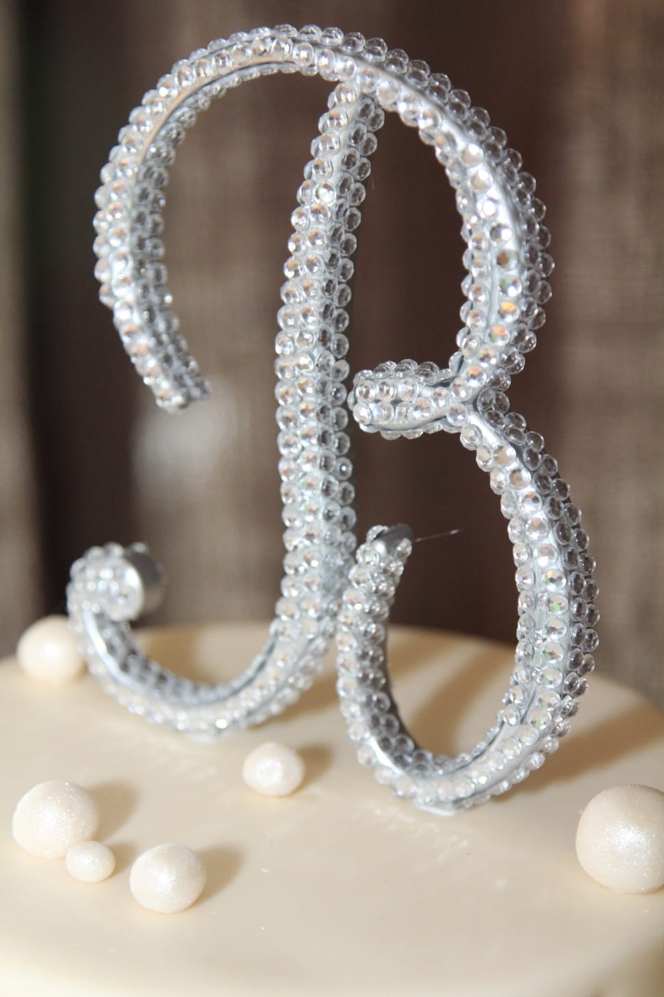 silver and diamond inverted letter b cake top decor preview