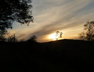 silhouette of mountain and trees during sunset thumbnail