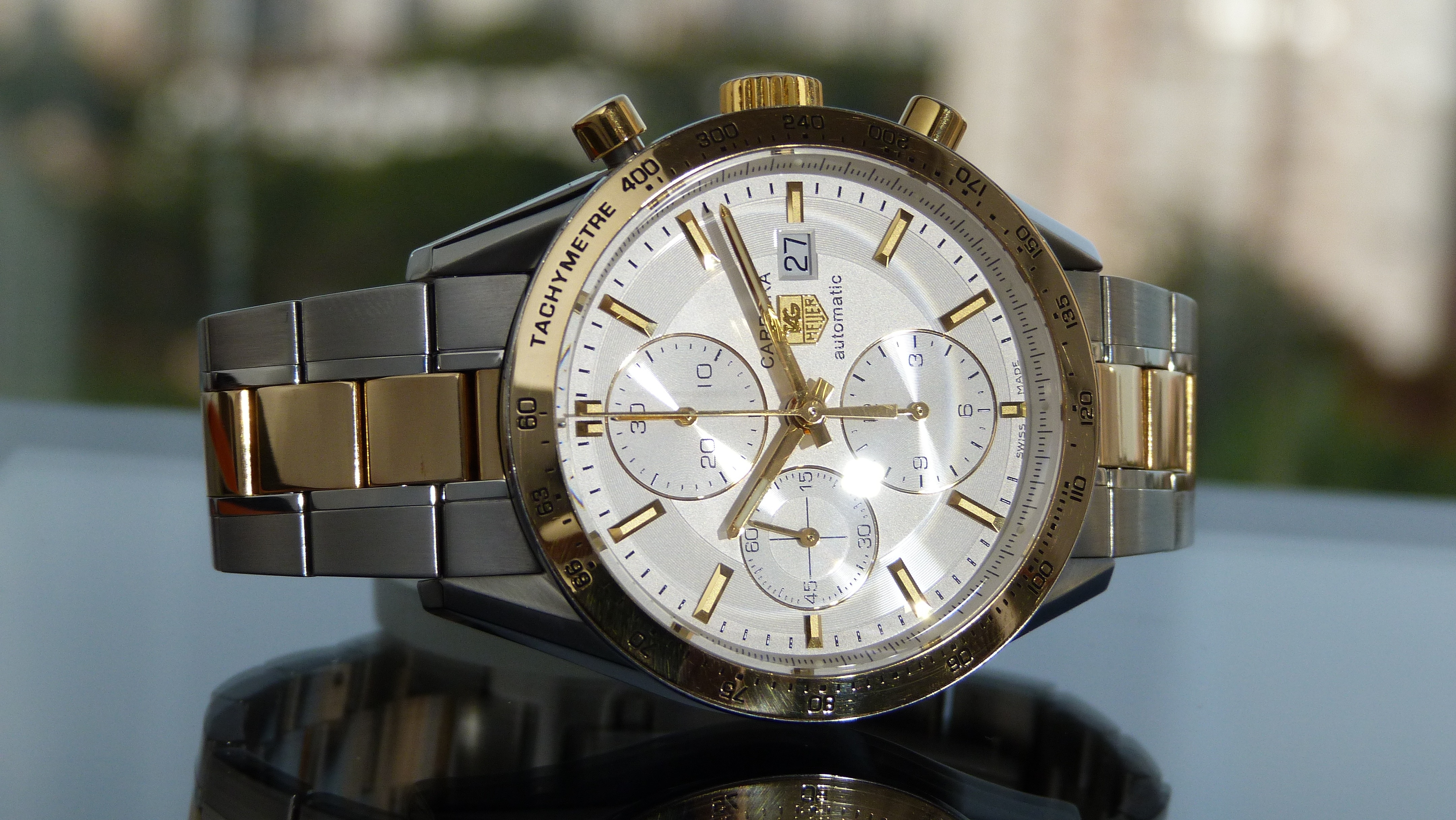 silver and gold link strap chronograph watch