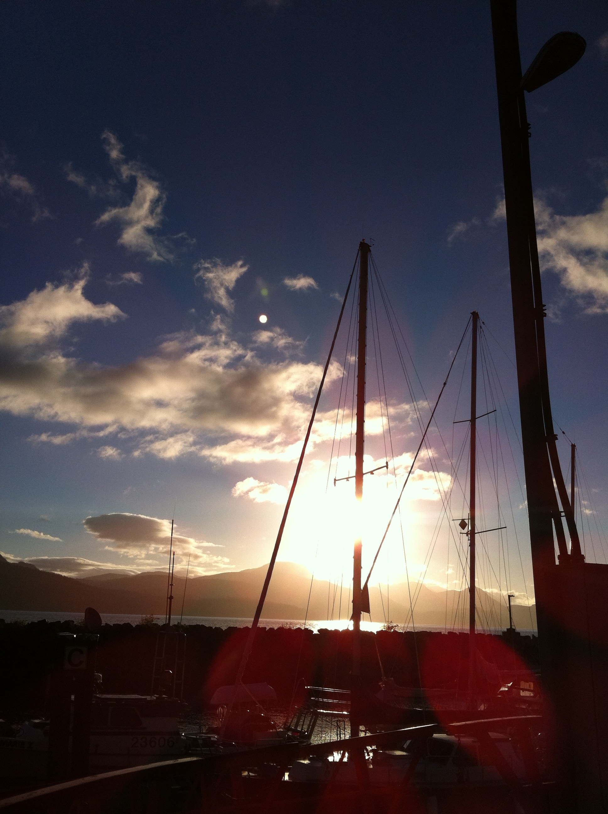 silhouette photograph of sailing boat during sunset
