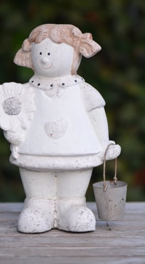 girl holding bucket and flower figurine thumbnail