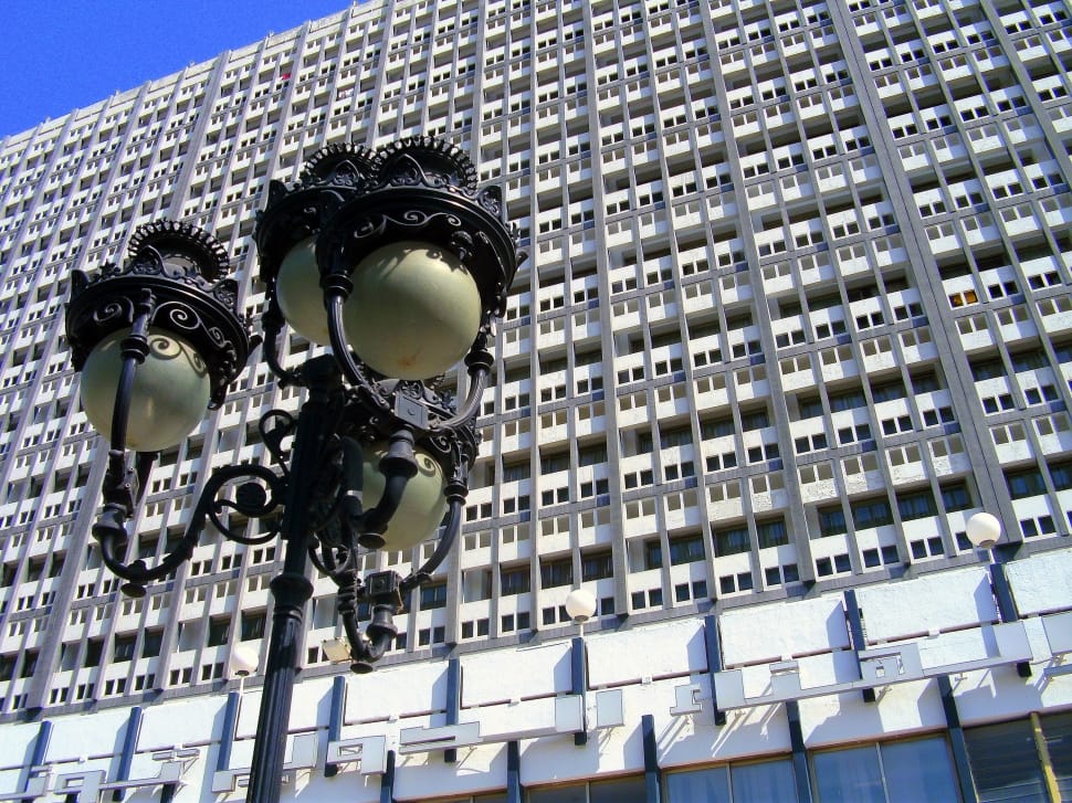 brown metal street lamp and white high rise building preview